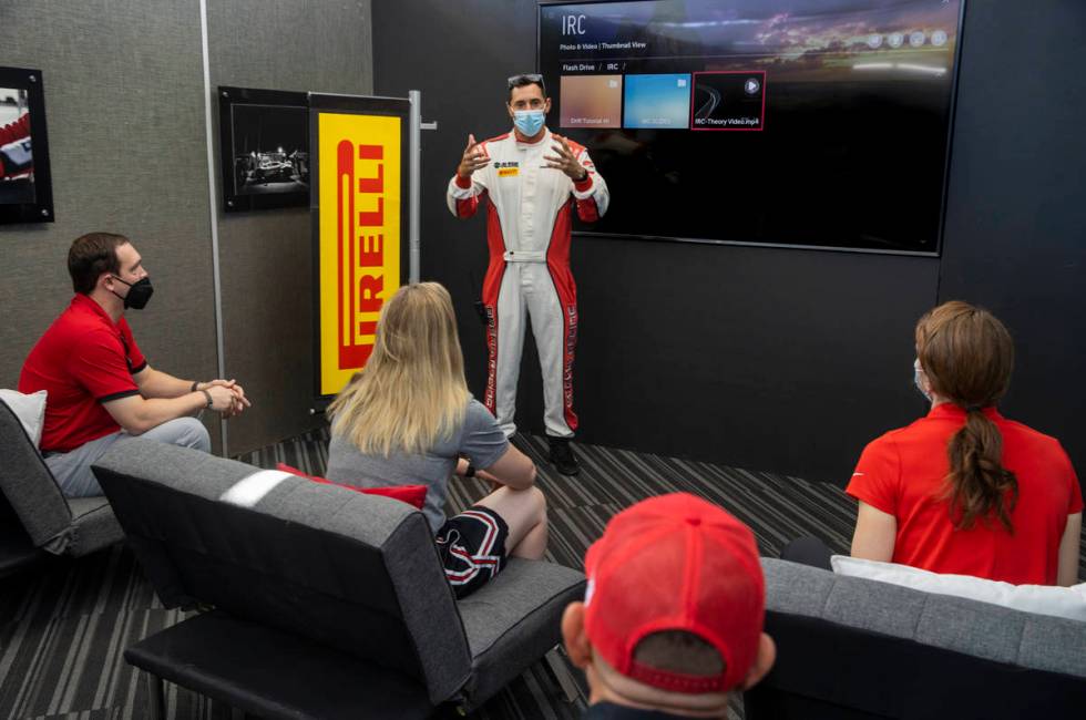 Dream Racing instructor Vinny Mykulak, center, gives UNLV coaches a briefing on driving techniq ...