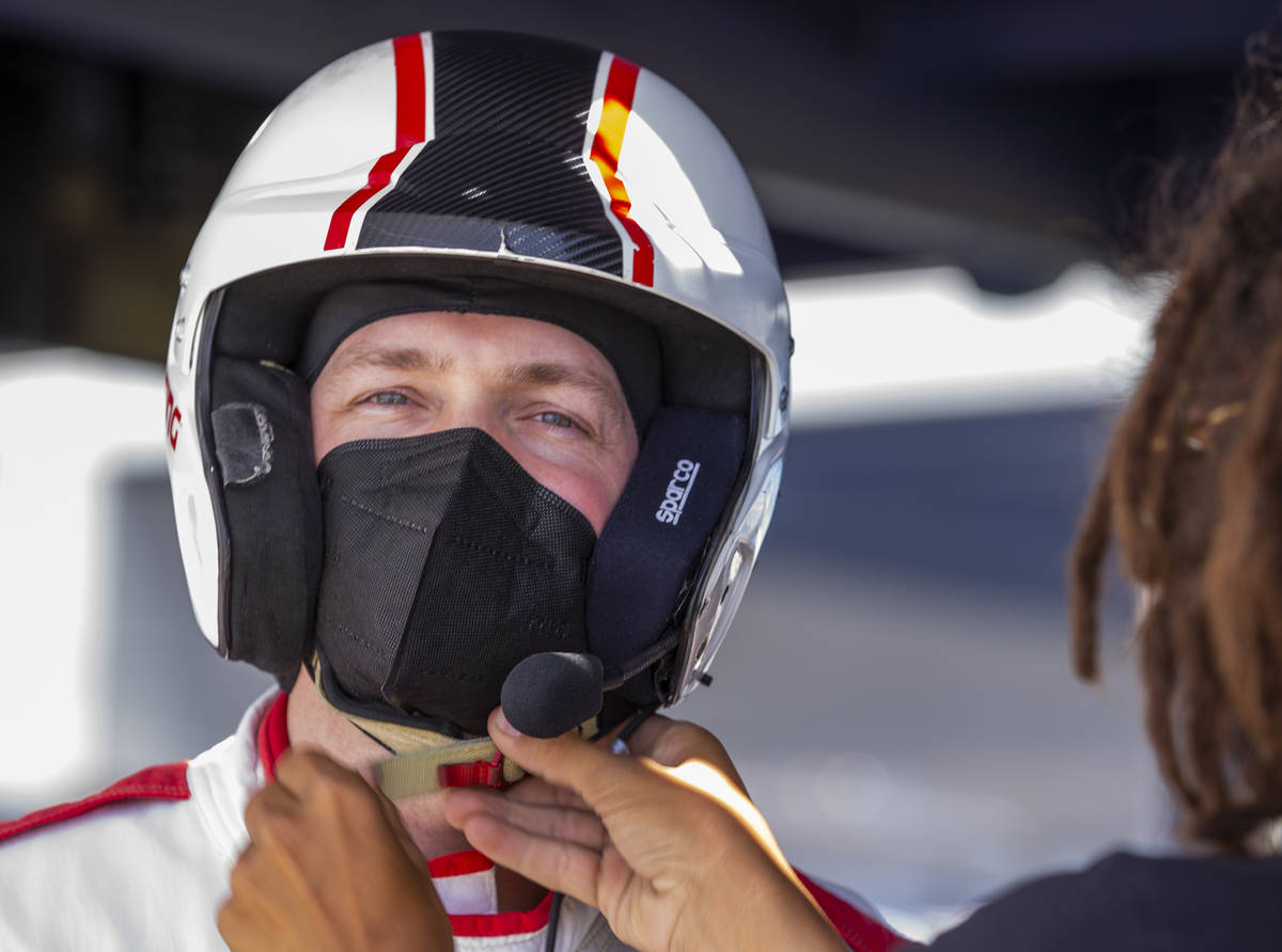 UNLV head men's basketball coach Kevin Kruger is fitted with a helmet before taking a few laps ...