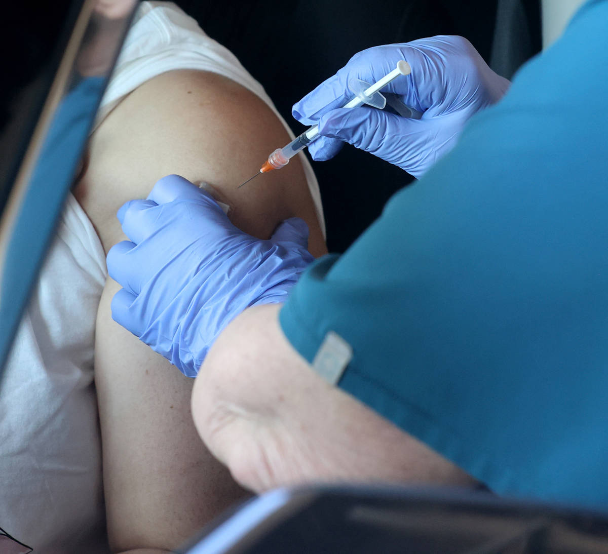 Teresa Woods gives a shot during a drive-thru COVID-19 vaccine clinic in the Bronze Lot at the ...