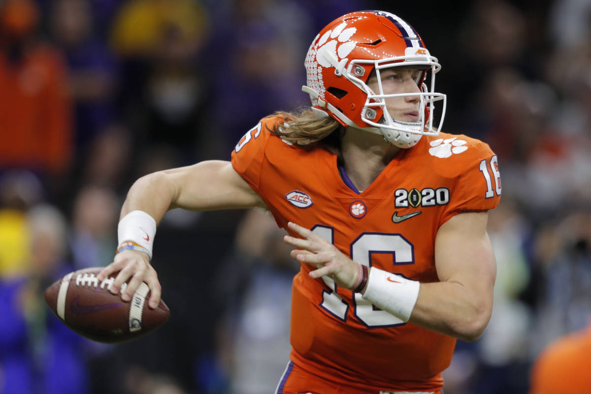 FILE - Clemson quarterback Trevor Lawrence passes against LSU during the second half of a NCAA ...