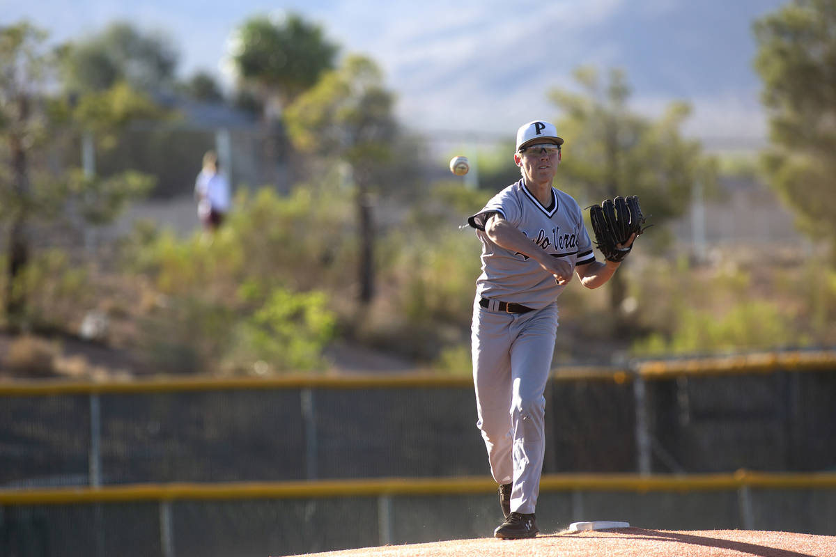 Palo Verde's pitcher Jacob Gonzalez (12) throws a pitch to first to stop Bishop Gorman from ste ...
