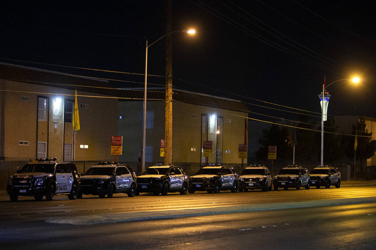 Metropolitan police squad cars line East Charleston Boulevard while police investigate a scene ...