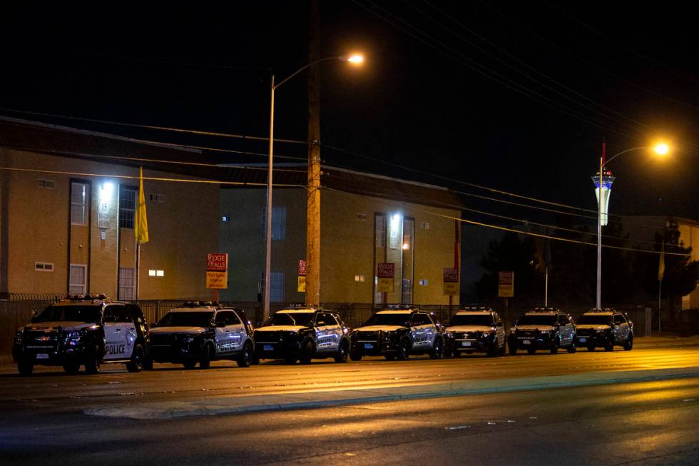 Metropolitan police squad cars line East Charleston Boulevard while police investigate a scene ...