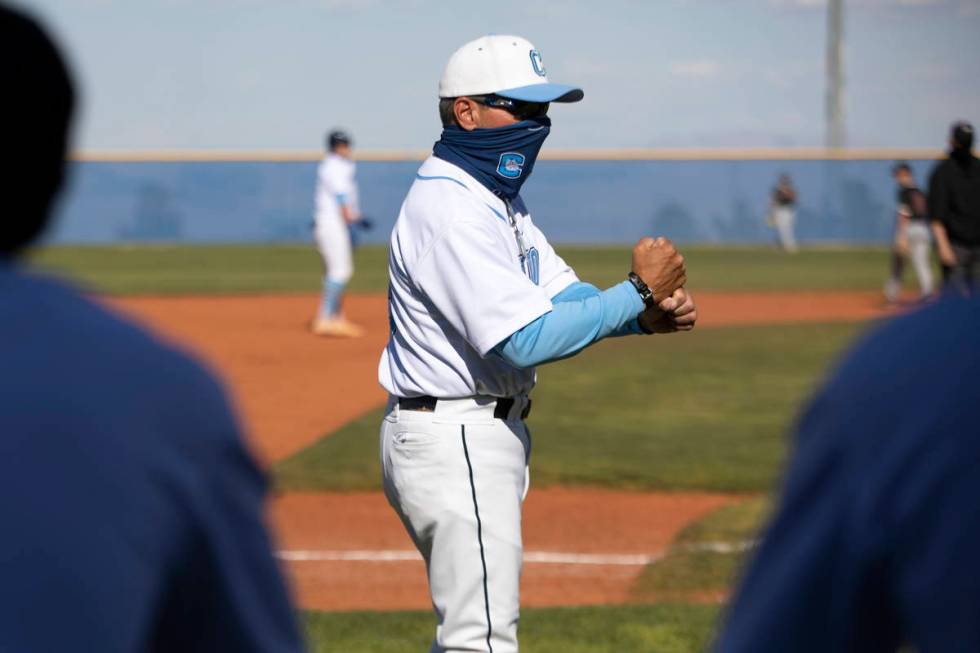 Centennial High School's baseball coach Charlie Cerrone gives batting tips from third base duri ...