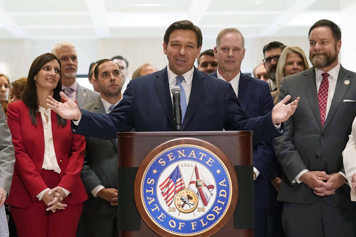 Surrounded by lawmakers, Florida Gov.Ron DeSantis speaks at the end of a legislative session, F ...