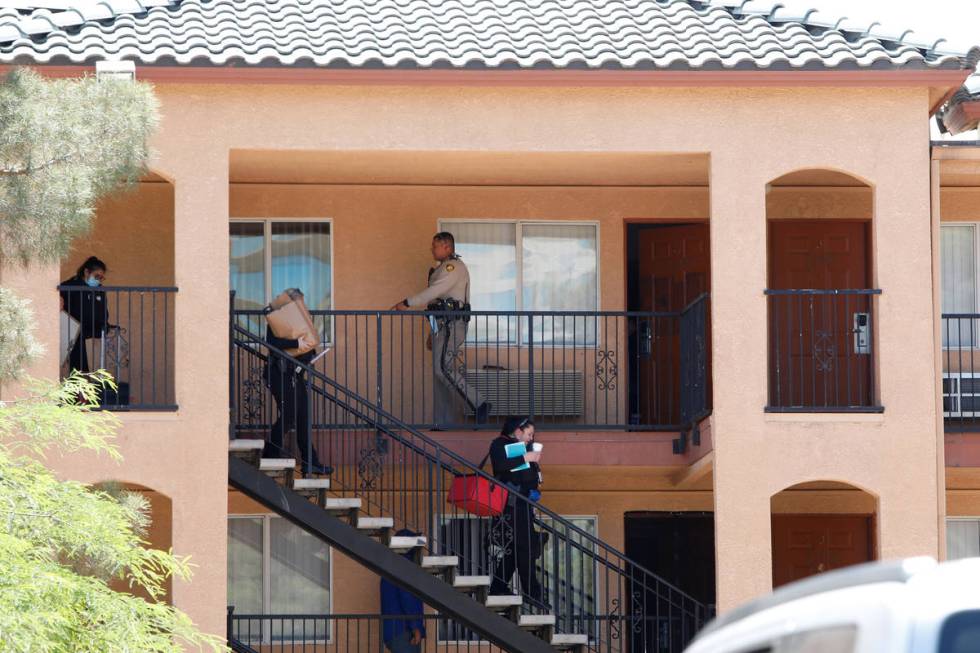 Las Vegas police and their Crime Scene Investigations team leave an apartment unit in Emerald S ...