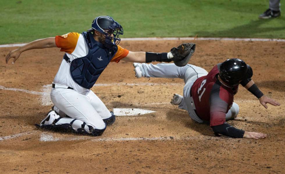 Las Vegas Aviators catcher Carlos Prez (23) tags out Sacramento River Cats infielder Just ...