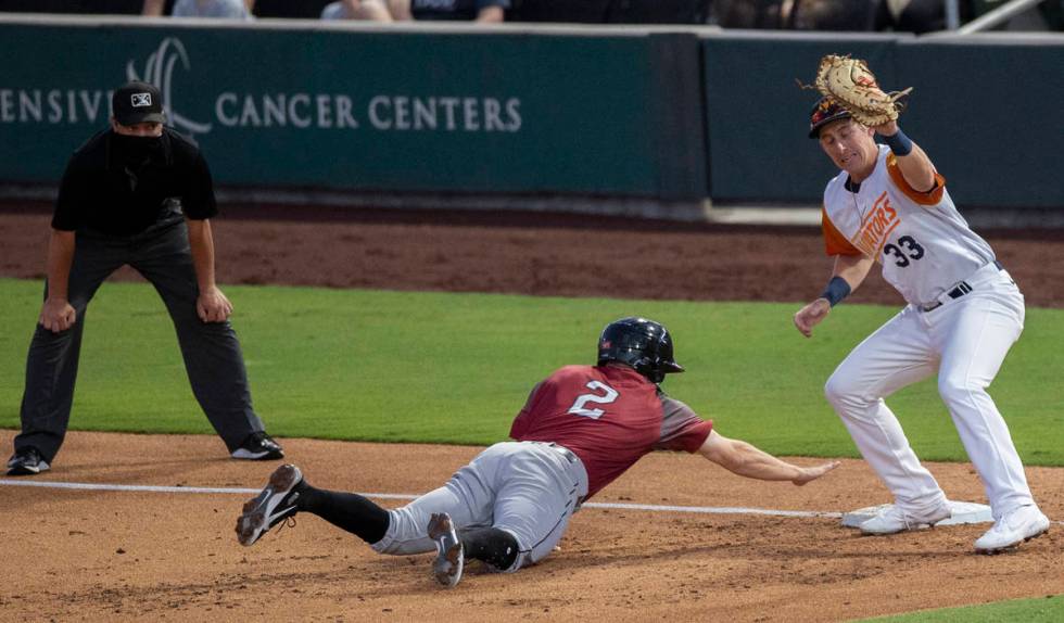 Las Vegas Aviators infielder Frank Schwindel (33) puts the tag on Sacramento River Cats infield ...