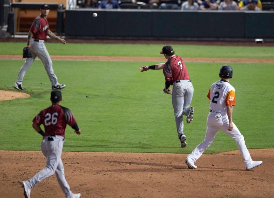 Sacramento River Cats infielder Mitchell Tolman (7) makes a leaping throw past Las Vegas Aviato ...