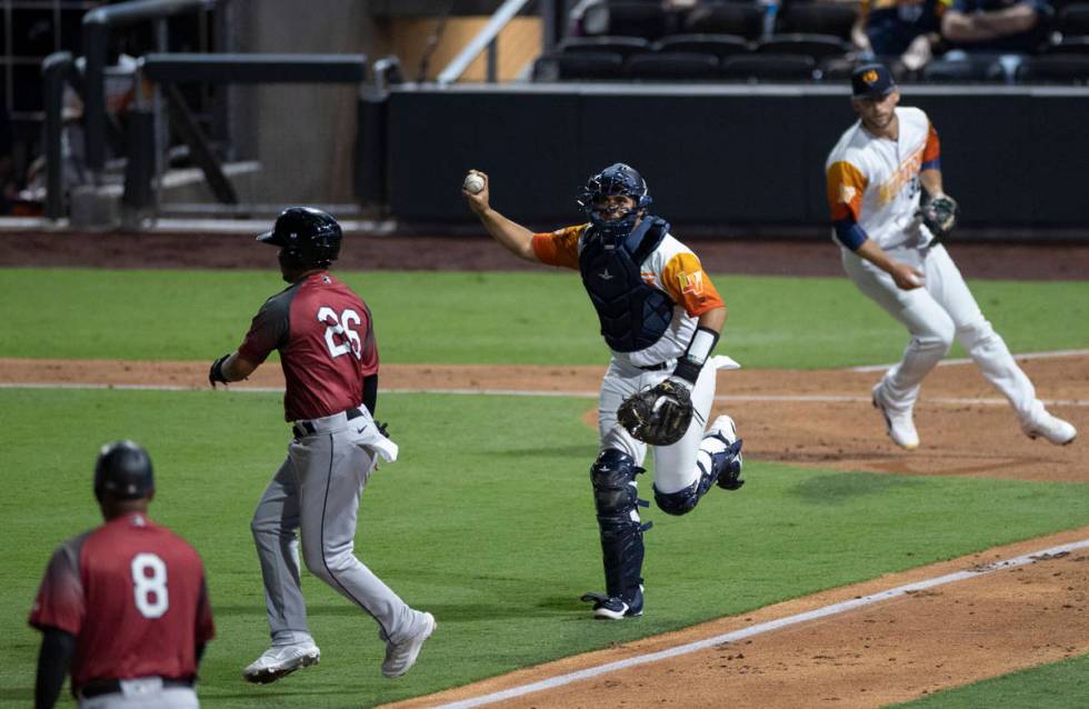 Las Vegas Aviators catcher Carlos Prez (23) chases Sacramento River Cats infielder Thairo ...