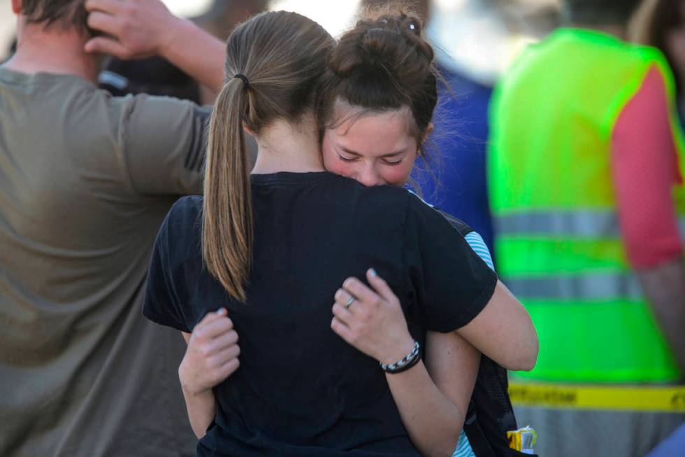 Students embrace after a school shooting at Rigby Middle School in Rigby, Idaho on Thursday, Ma ...
