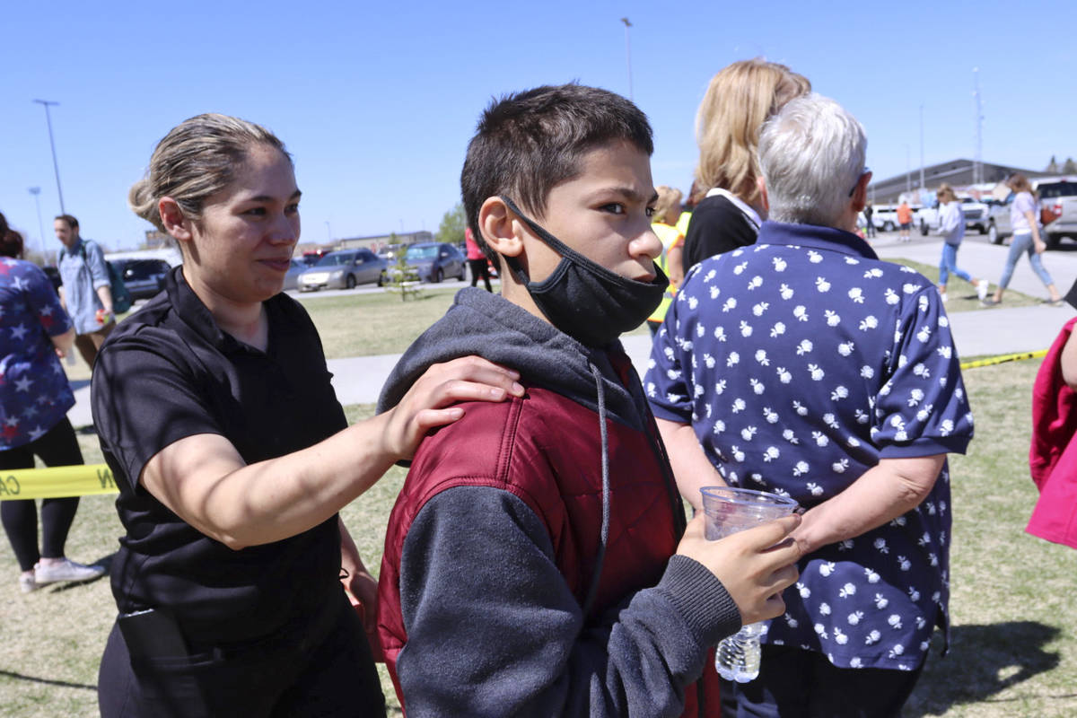 Adela Rodriguez, left, walks with her son, Yandel Rodriguez, 12, at the high school where peopl ...