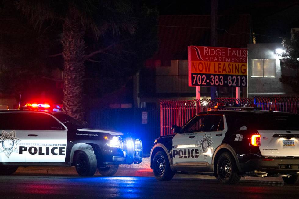 Las Vegas police investigate the scene where an officer opened fire near the 3000 block of East ...