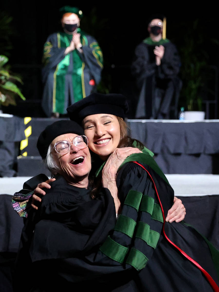 Zarah Rosen gets a hug from her grandmother Harriet Rosen after the senior Rosen hooded her gra ...