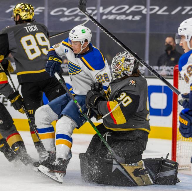 Golden Knights goaltender Robin Lehner (90) pushes St. Louis Blues left wing Mackenzie MacEache ...