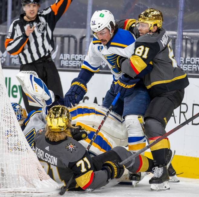 Golden Knights center William Karlsson (71) is taken down on the ice by St. Louis Blues goalten ...