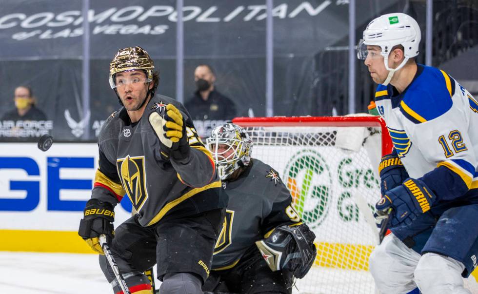 Golden Knights defenseman Alec Martinez (23) eyes a puck to slap down with St. Louis Blues left ...