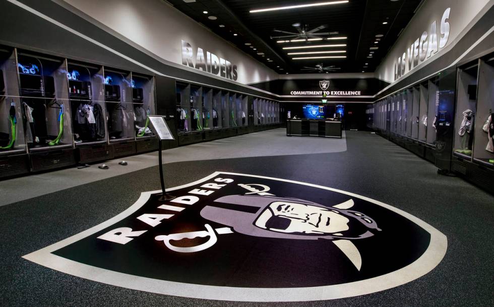 A large logo is painted on the floor in the expansive locker room within the Las Vegas Raiders ...