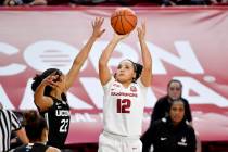 Arkansas guard Destiny Slocum (12) shoots over Connecticut defender Evina Westbrook (22) during ...