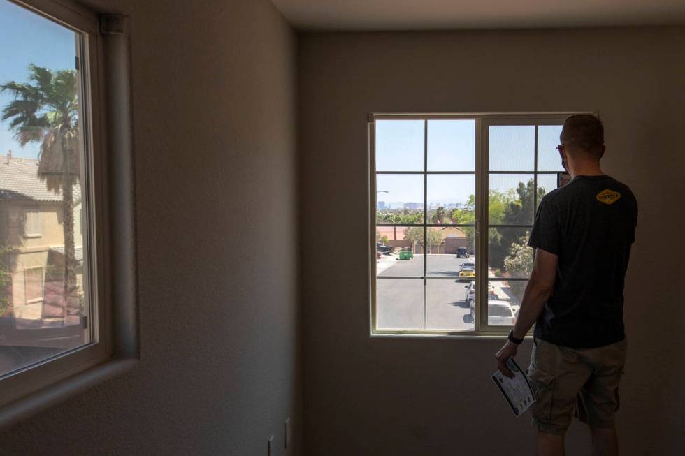 Joshua Winningham video chats with his wife, noting the view of the Las Vegas Strip, during an ...