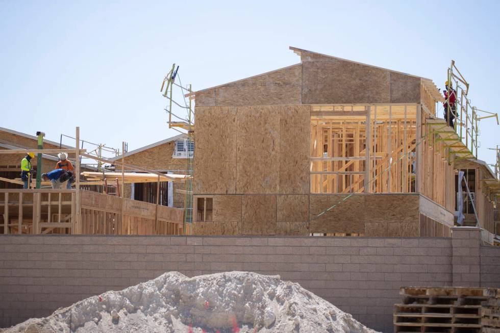 Construction workers build new homes near W Elkhorn Road and N Aviary Way in North Las Vegas, F ...