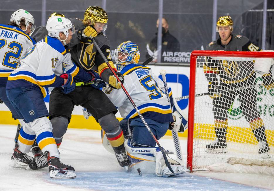 Golden Knights center William Karlsson (71) battles near the net for a scoring opportunity over ...