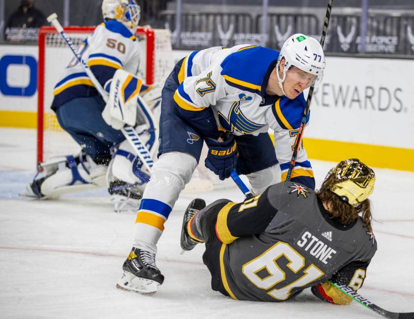 St. Louis Blues defenseman Niko Mikkola (77) knocks Golden Knights right wing Mark Stone (61) t ...