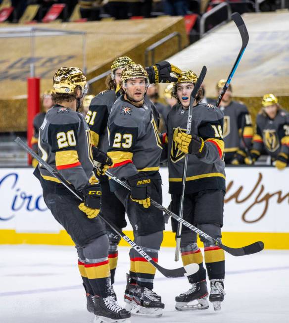 Golden Knights defenseman Alec Martinez (23) is celebrated with teammates for a goal over the S ...