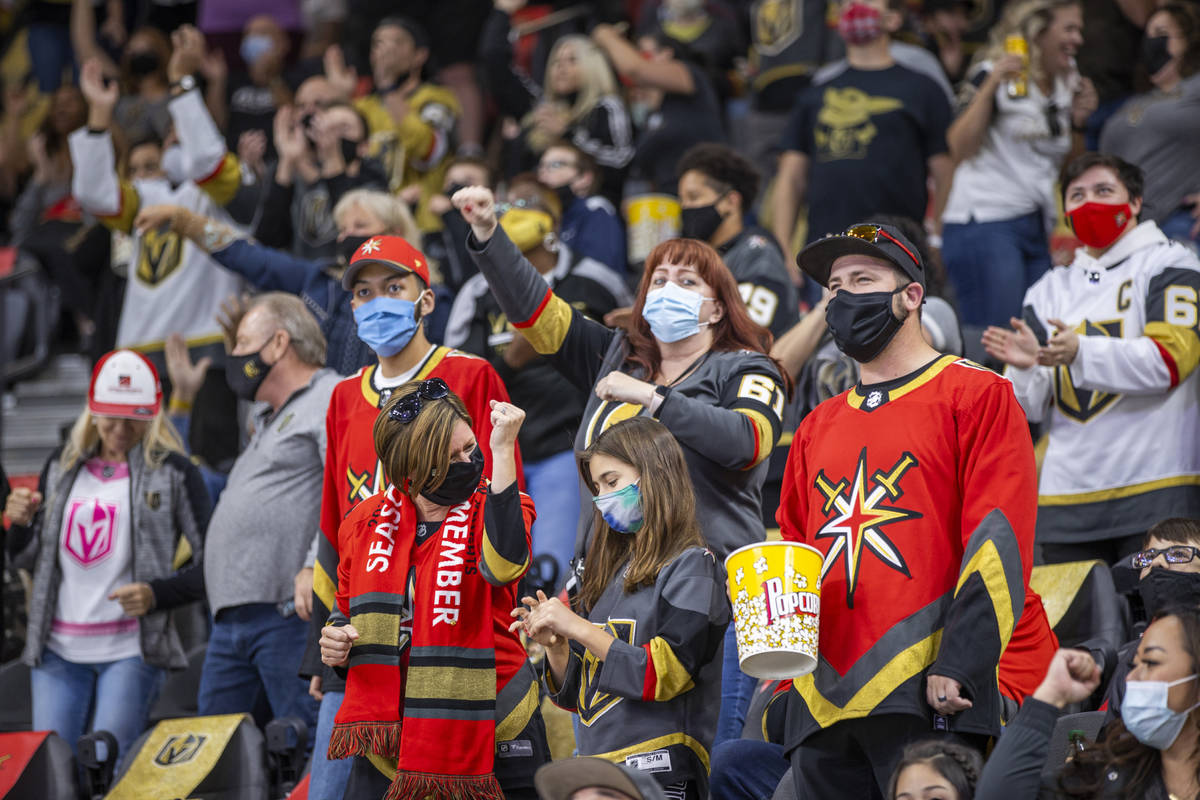 Golden Knights fans celebrate a goal by defenseman Alec Martinez (23) over the St. Louis Blues ...