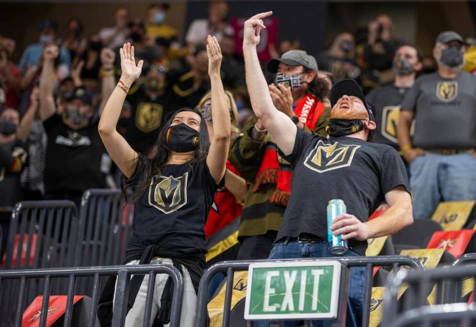Golden Knights fans celebrate a goal during the third period of an NHL game versus the St. Loui ...