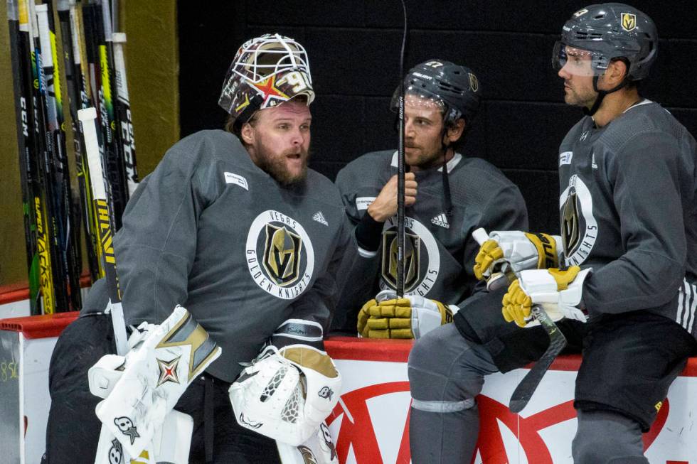 Vegas Golden Knights goaltender Robin Lehner (90, left) chats with defenseman Shea Theodore (27 ...