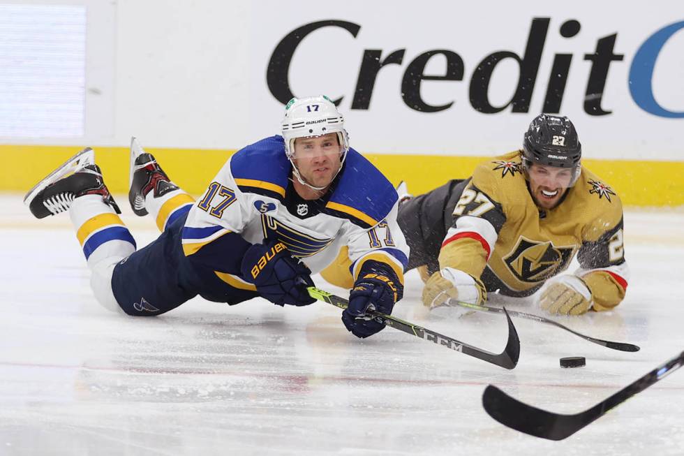 Vegas Golden Knights defenseman Shea Theodore (27) and St. Louis Blues left wing Jaden Schwartz ...