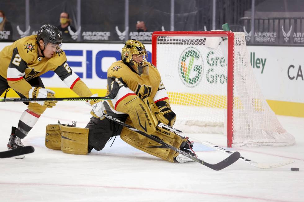 Vegas Golden Knights goaltender Marc-Andre Fleury (29) with defenseman Zach Whitecloud (2) defe ...