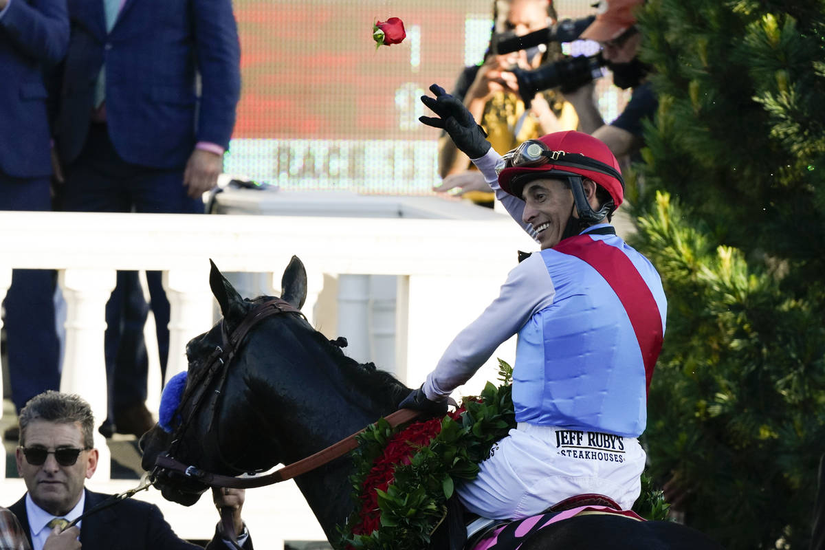John Velazquez riding Medina Spirit throws a rose after his victory in the 147th running of the ...