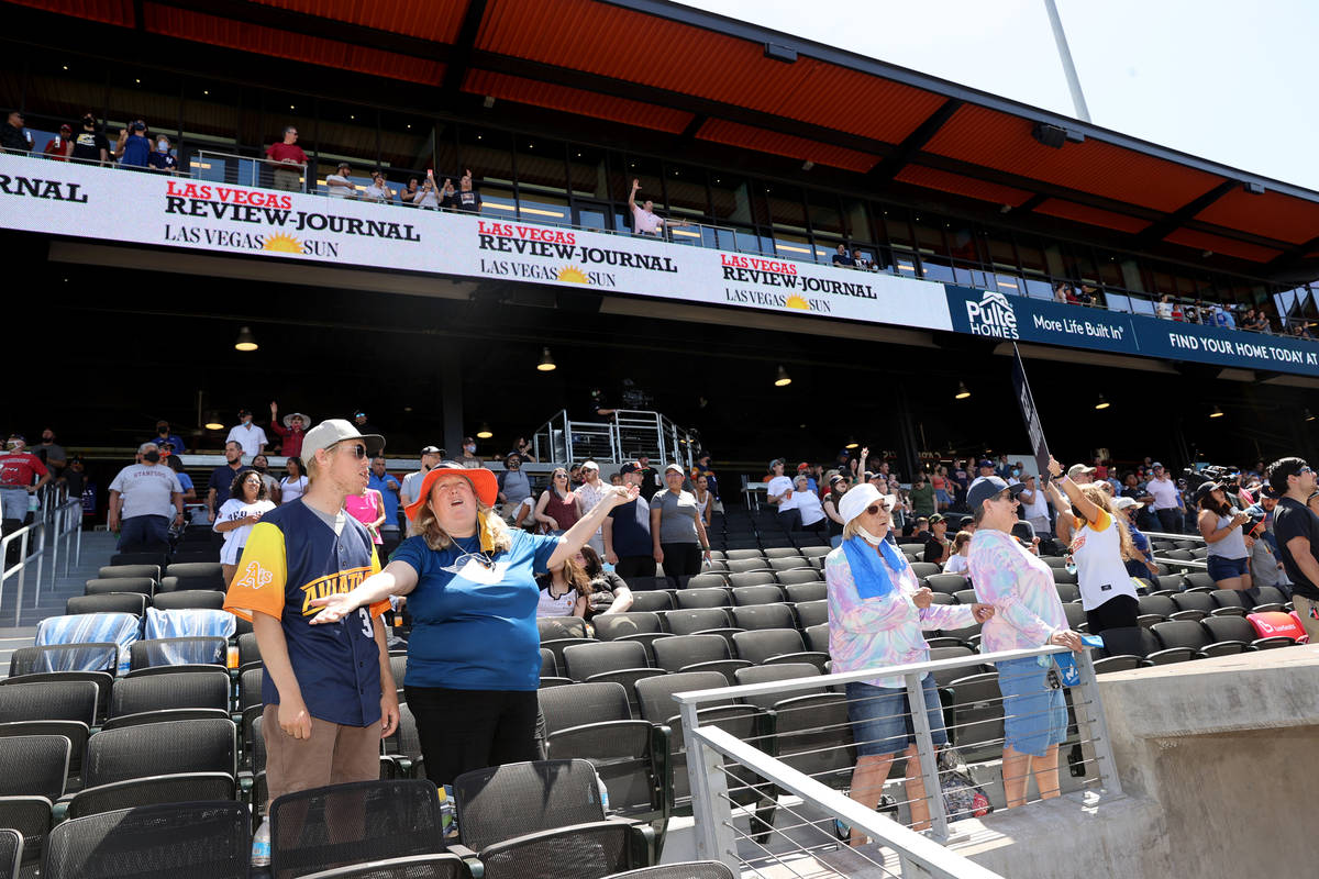 Maria Engdahl and her son Mitchell, 17, sing "Take Me Out to the Ballgame" during the ...