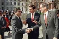 FILE - In this April 27, 1987, file photo, Massachusetts Governor Michael Dukakis, left, shakes ...