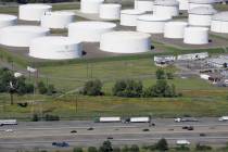 In this Sept. 8, 2008 file photo traffic on I-95 passes oil storage tanks owned by the Colonial ...