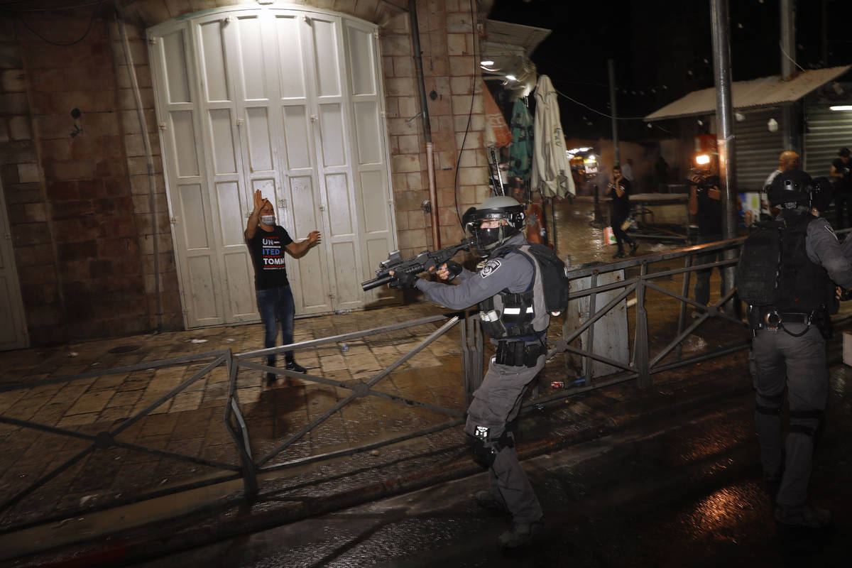 Israeli police officers aims his rifle during clashes with Palestinians near Damascus Gate just ...