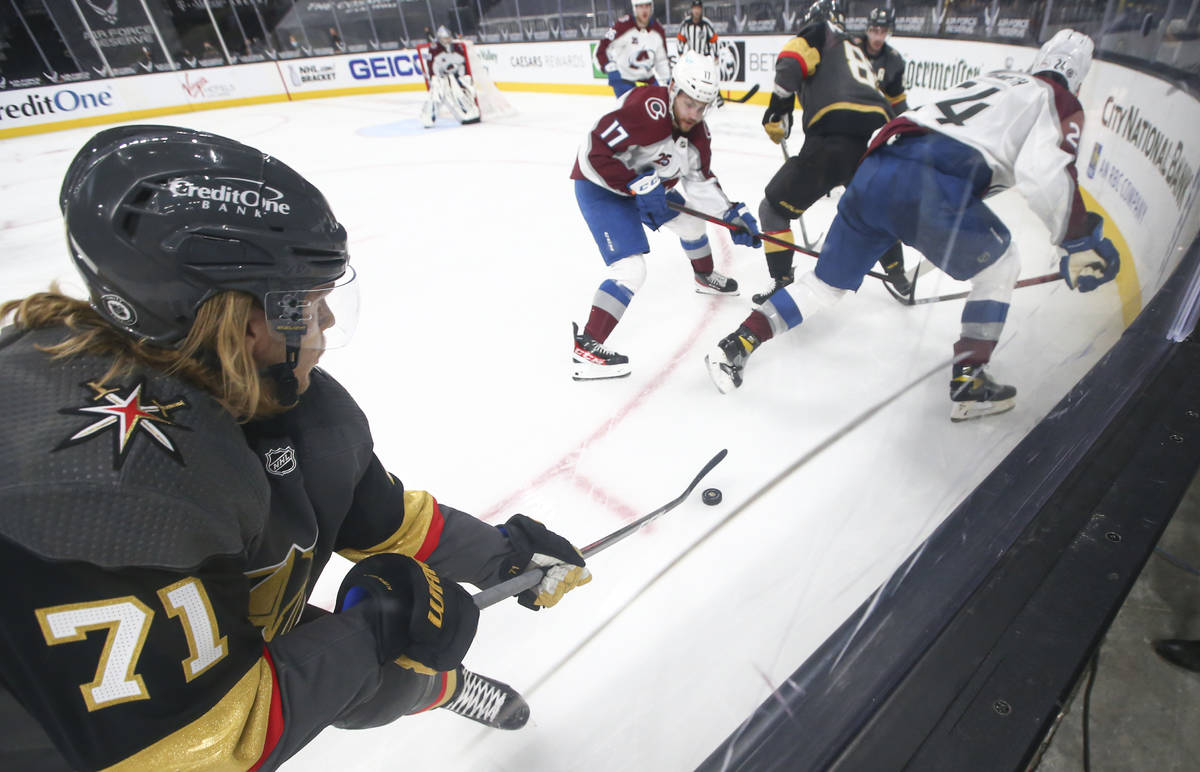 Golden Knights' center William Karlsson (71) controls the puck under pressure from the Colorado ...