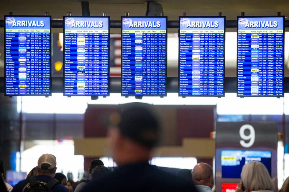 Screens show the arrivals times at McCarran International Airport Terminal 1 in Las Vegas, Thur ...