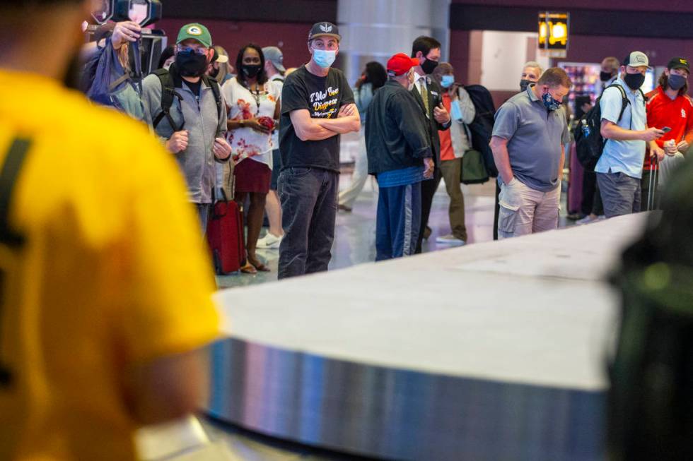 Travelers wait for their luggage at McCarran International Airport Terminal 1 in Las Vegas, Thu ...