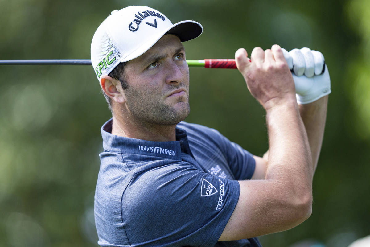 Jon Rahm watches his tee shot on the 3rd hole during the first round of the Wells Fargo Champio ...