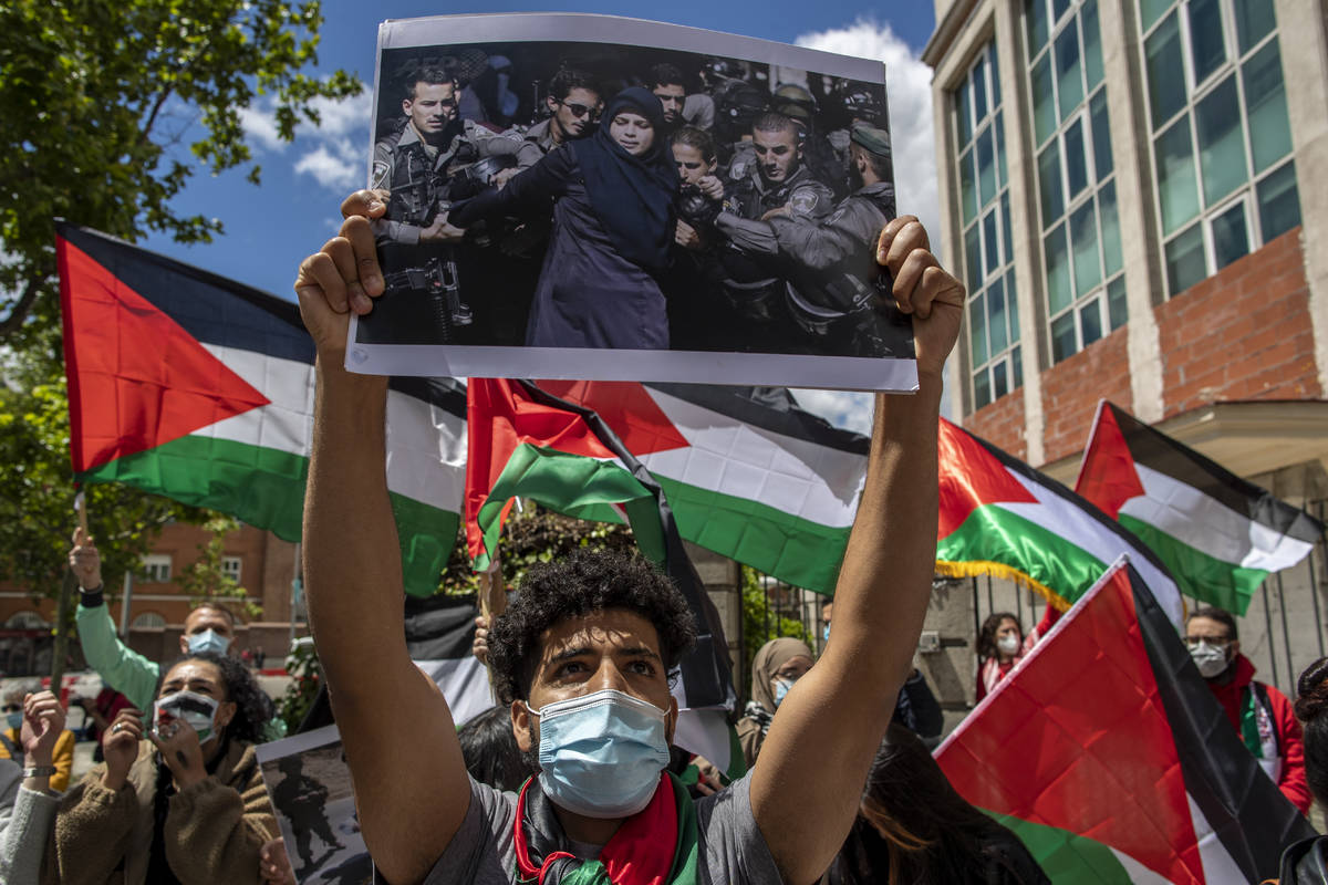 Protesters shout slogans and wave Palestinian flags in support of Palestinians during the lates ...