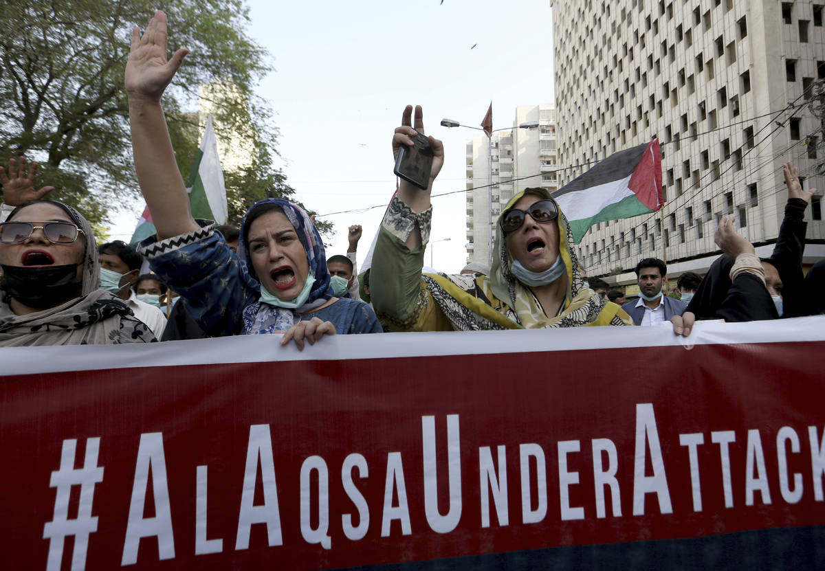 Members of a civil society group chant anti-Israeli slogans during a demonstration in support o ...