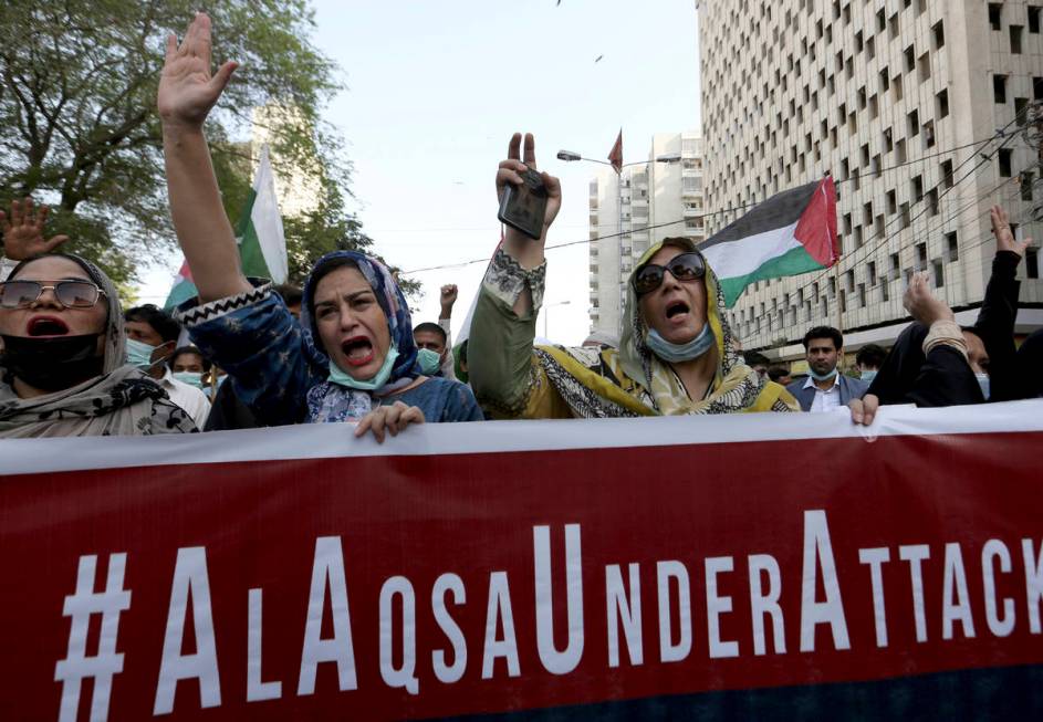 Members of a civil society group chant anti-Israeli slogans during a demonstration in support o ...