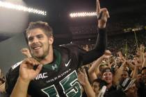 In this Nov. 23, 2007, file photo, then-Hawaii quarterback Colt Brennan celebrates after an NCA ...