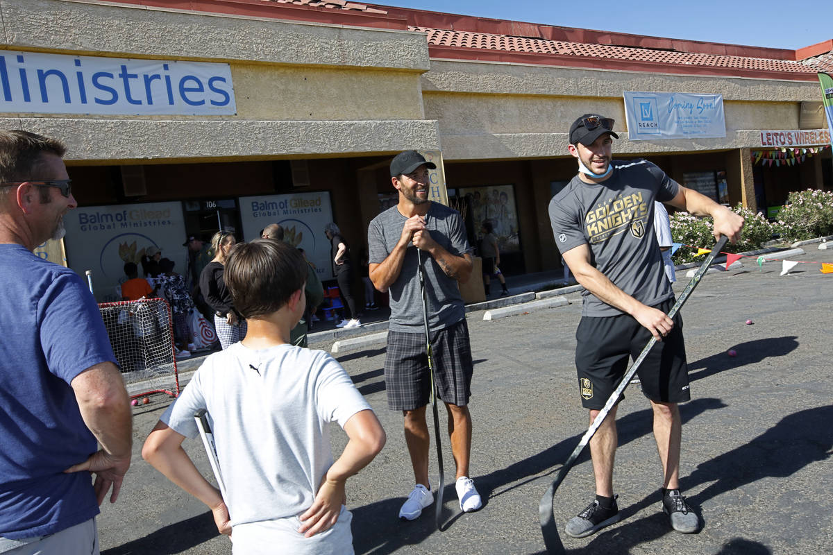 Former Golden Knights player Deryk Engelland, second from right, and Harrison Luce, youth hocke ...