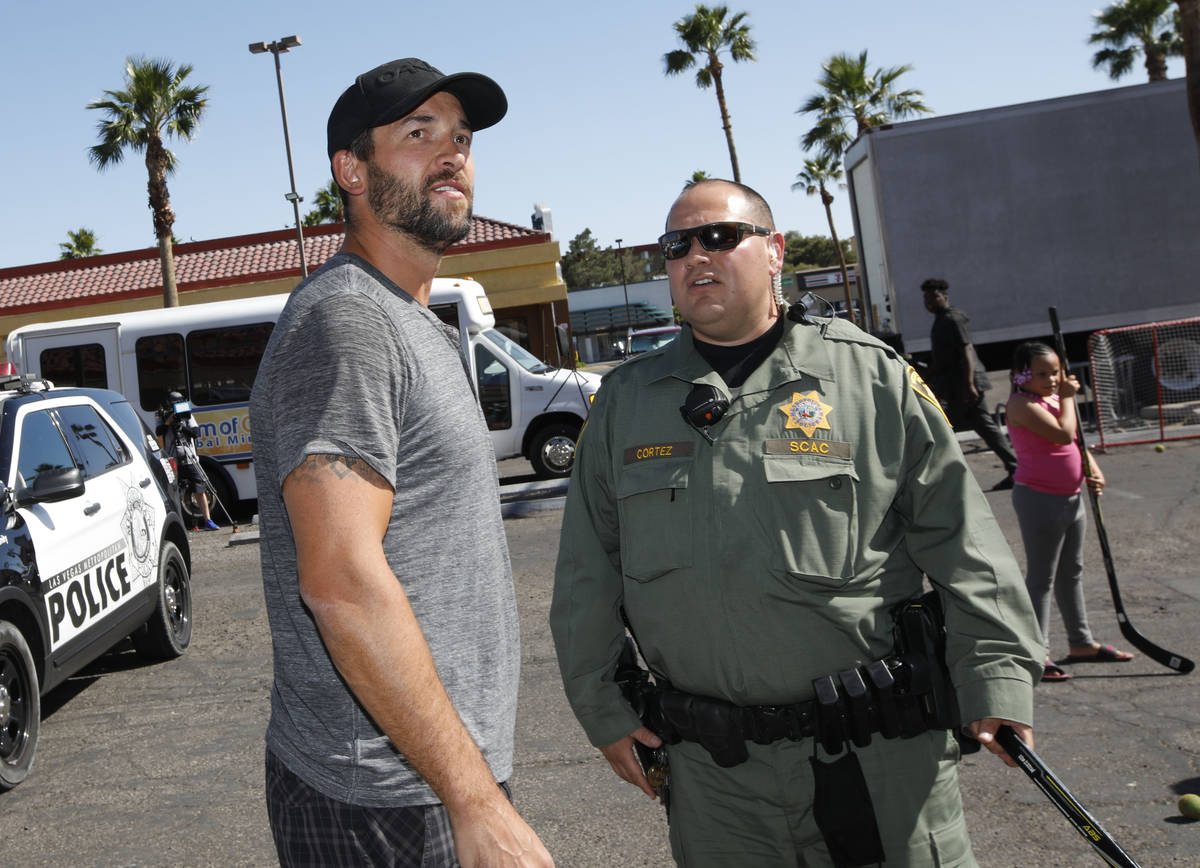 Former Golden Knights player Deryk Engelland, left, talks with Las Vegas police officer Sam Cor ...
