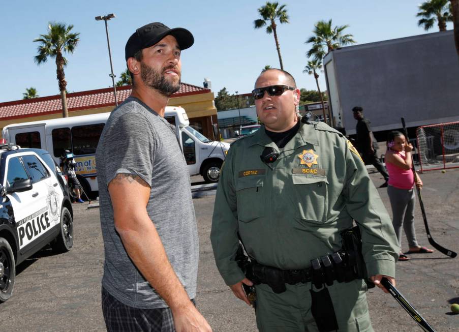 Former Golden Knights player Deryk Engelland, left, talks with Las Vegas police officer Sam Cor ...