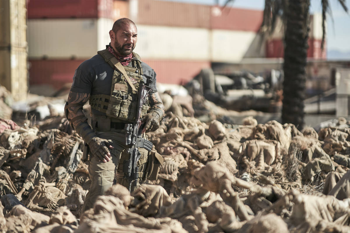 Scott Ward (Dave Bautista) is up to his waist in skeletons in a scene from "Army of the Dead." ...